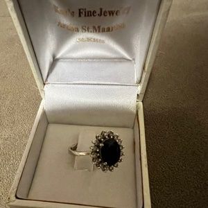 Silver and Gold Diamond ring with blue stone inside.